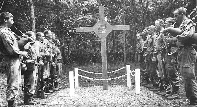 The Long Tan Cross – one of only two such crosses allowed in Vietnam To commemorate the acts of bravery of 107 (Photo: The Piper’s Lament, dedication of the battlefield memorial, the Long Tan Cross, 18 August 1969, to those who died in the Battle of Long Tan, 18 August 1966. [AWM negative BEL/69/0556/VN]