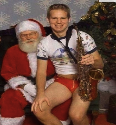 A younger Matt Blomfield sitting on Santas knee dangerously close to old Nicks knob